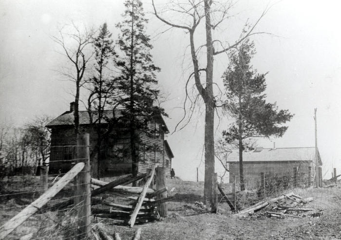 black and white photo of farm and house