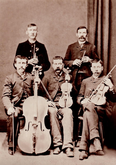 black and white portraitof 5 men and instruments