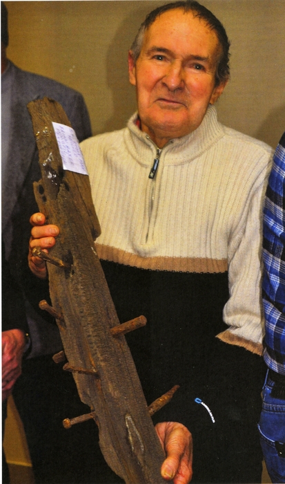 man with decayed wood beam from ship